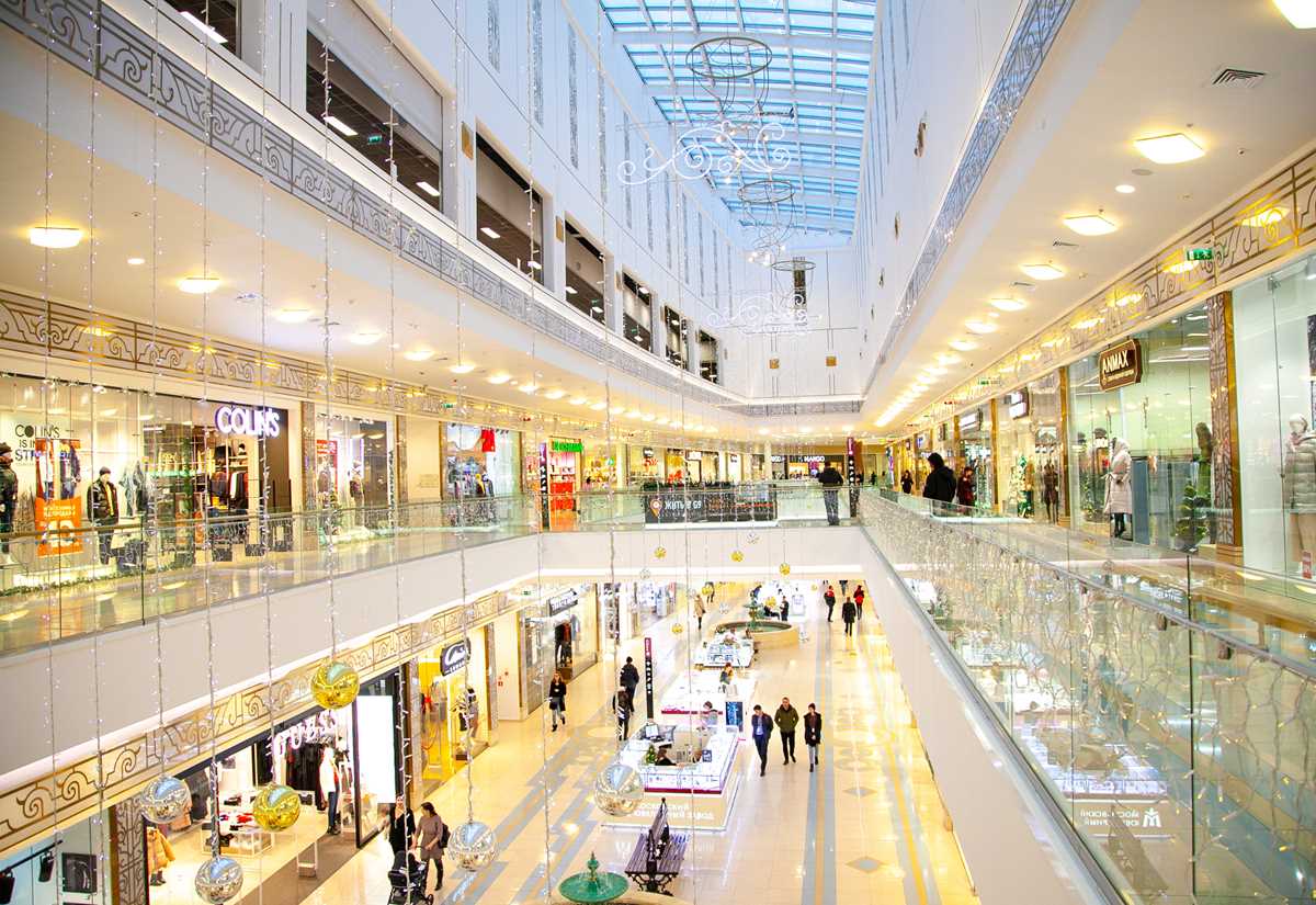 Inside a well-lit shopping mall with plenty of retail outlets