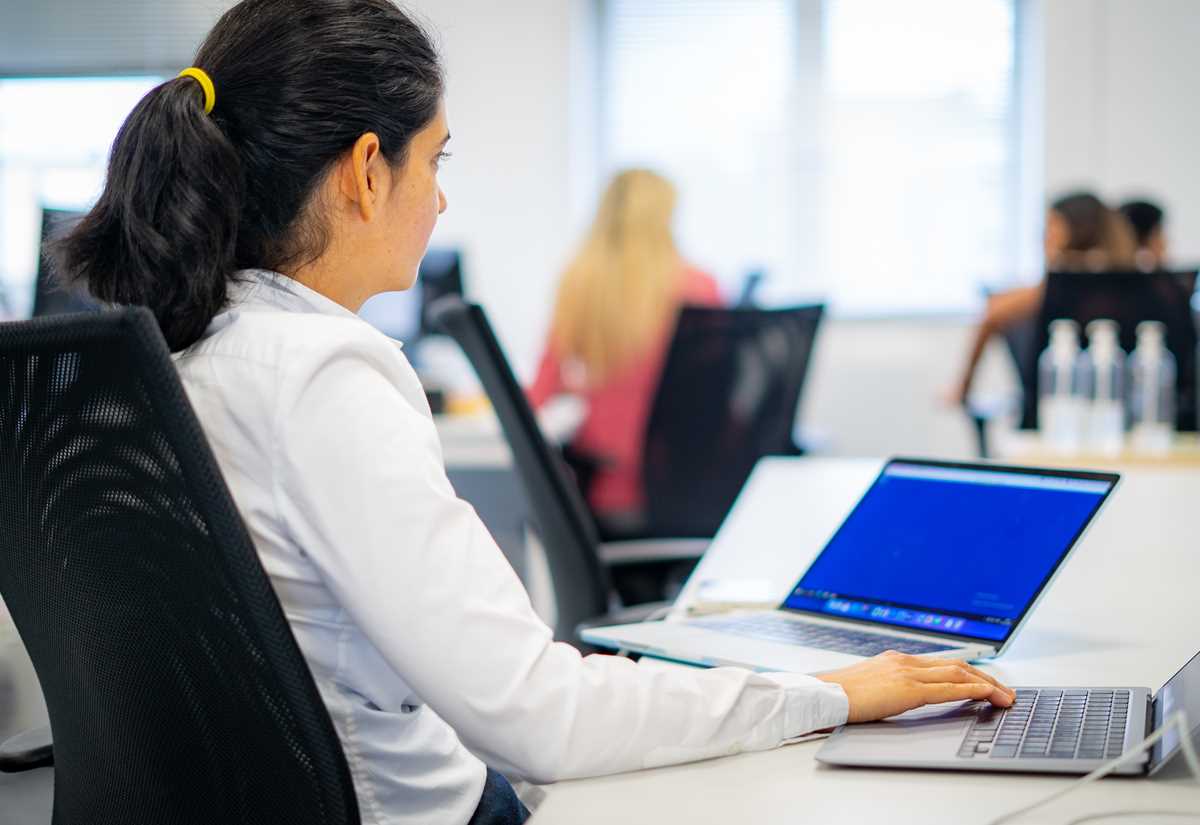 Woman working on a laptop in an office