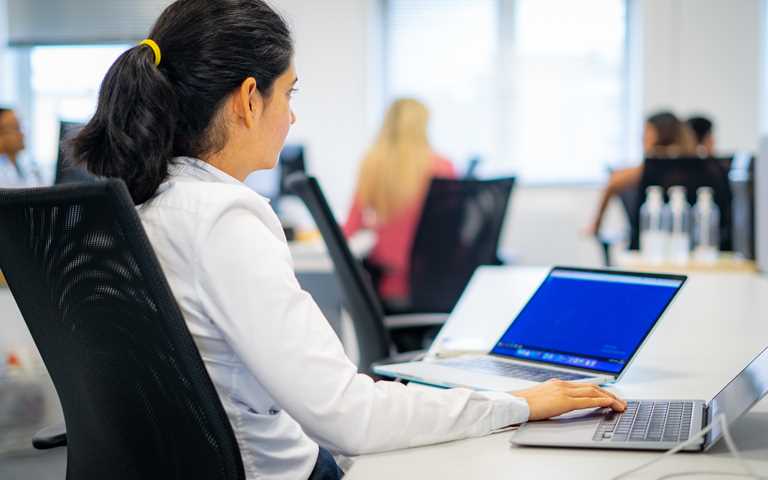 Woman working on a laptop in an office