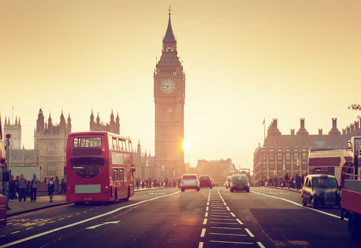 A picture showcasing transportation and services in the centre of London opposite Big Ben