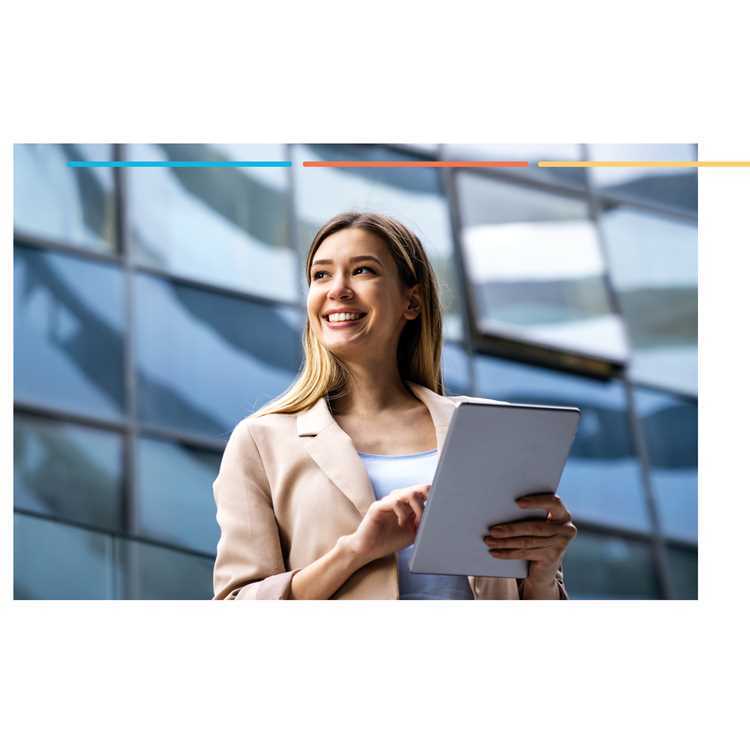 Smiling businesswoman holding a tablet in front of a glass office building