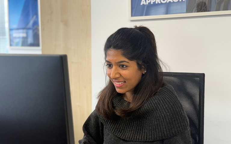 Smiling woman working at a desk in an office