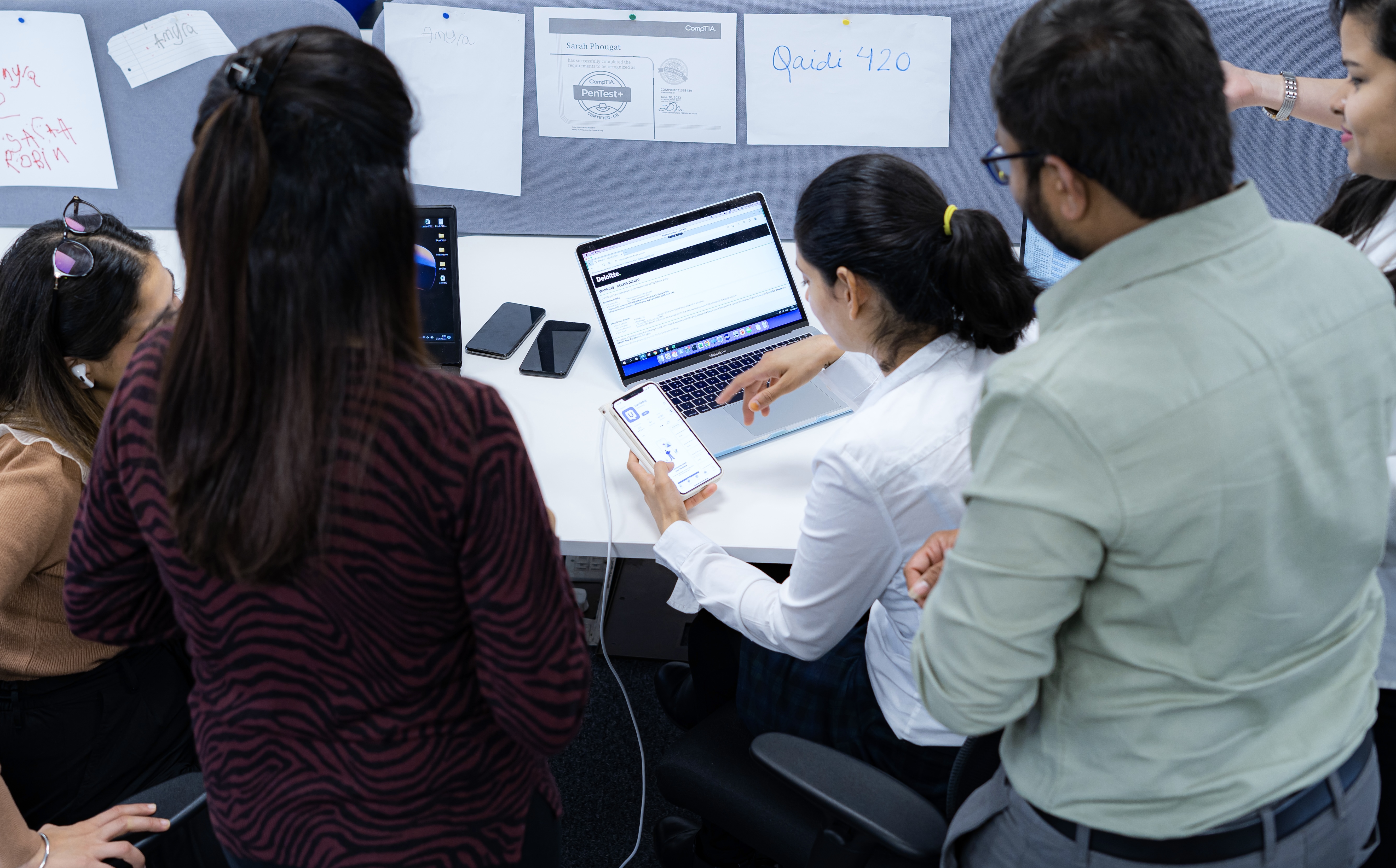 Two Software Testing Consultants reviewing a project gantt chart on a computer monitor