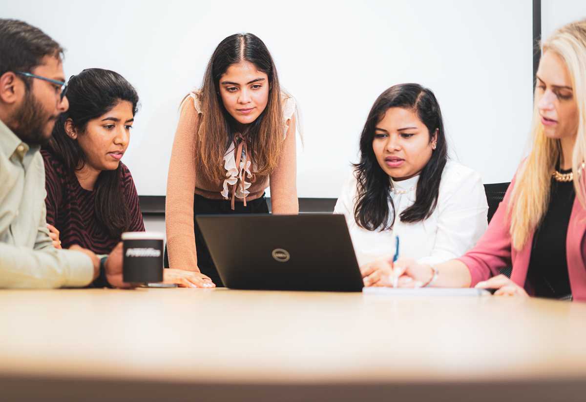 Software Testing Consultants reviewing bar charts and graphs